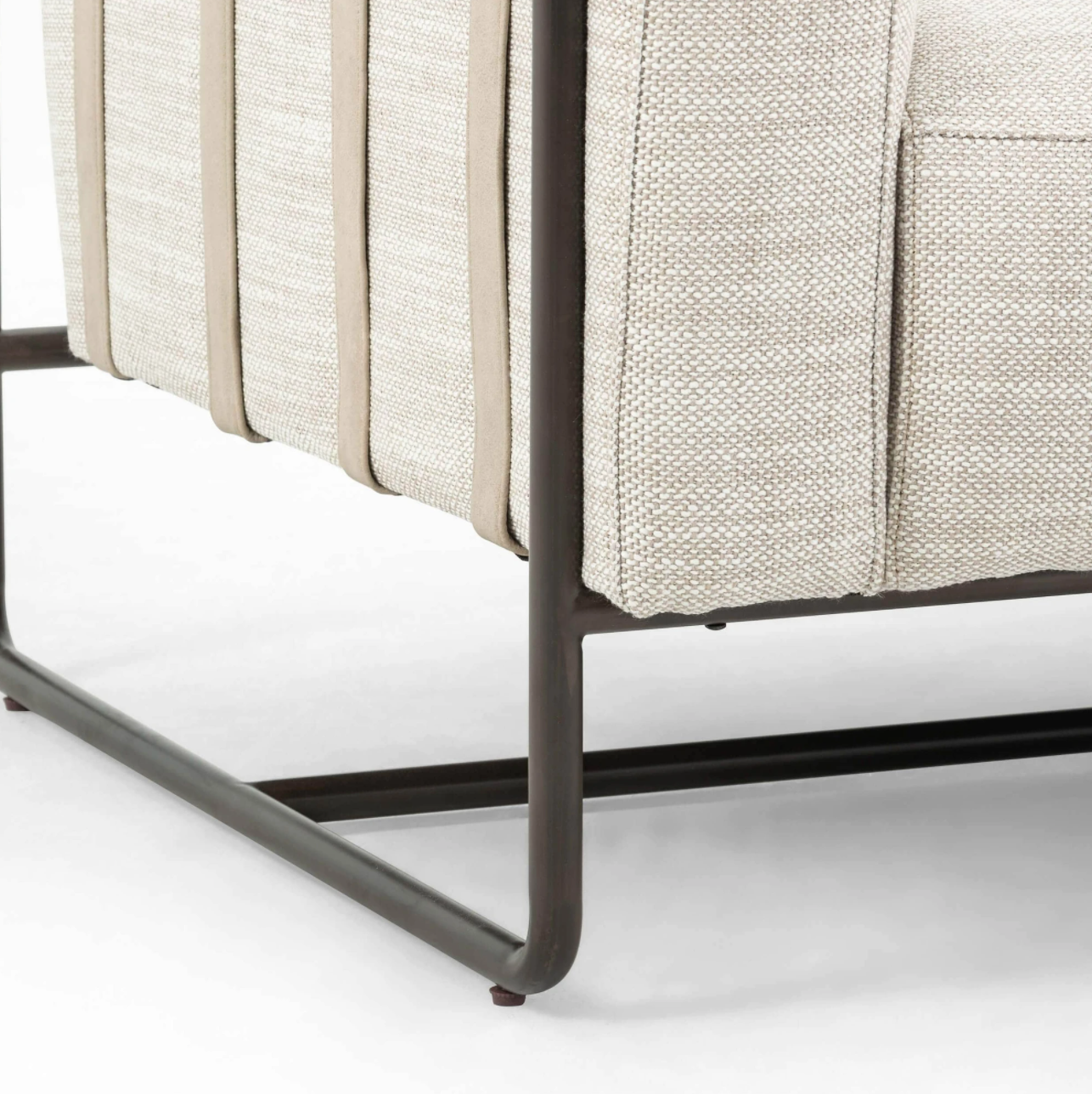 SHOP MY PICK: This leather strap suspended sofa is about as unique as they come. It features a black iron base, leather straps, rubberwood paneling, and beautiful taupe colored upholstered seating that appears to be floating.