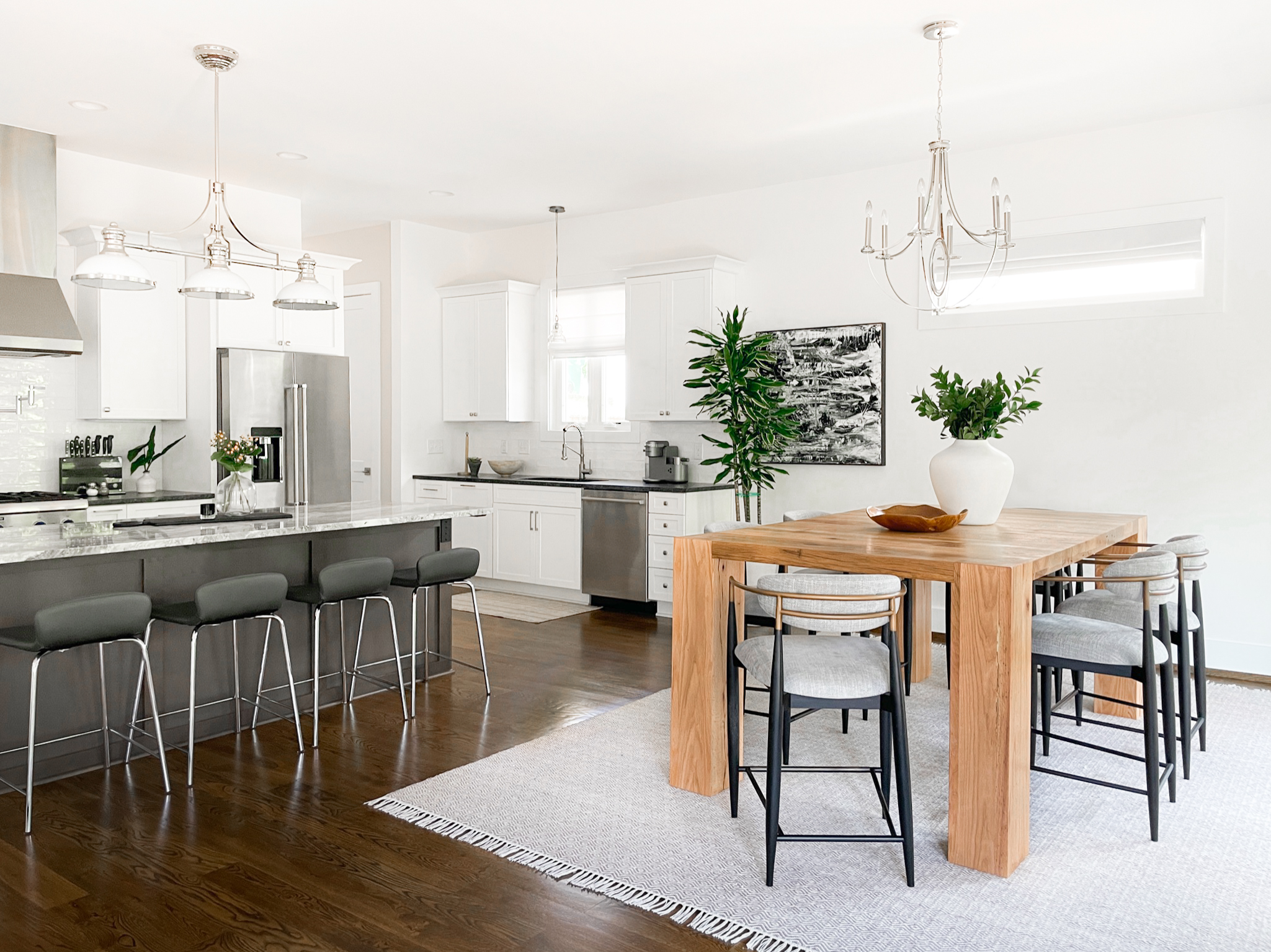 Our White Bridge project features dark wood floors and white walls furnished with warm wood tones, shades of white, and a splash of color.